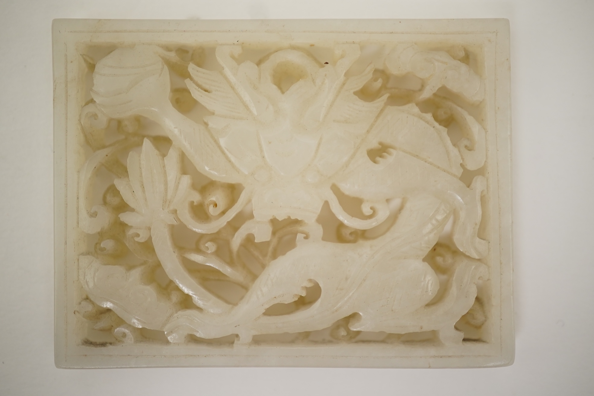 A Chinese reticulated white jade ‘dragon’ plaque, 18th century